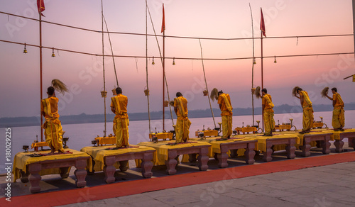 Photography Ganga aarti ceremony ritual performed by priests at the Ganges river bank Varanasi India at dawn
