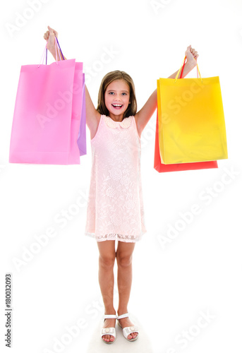 Adorable little girl child holding shopping colorful paper bags isolated
