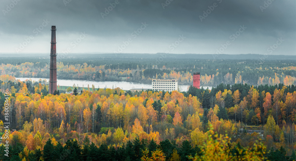 Picturesque view on valley of a national park. Trees changing colors in foothills. Colorful Autumn day at Ogres Zilie kalni.