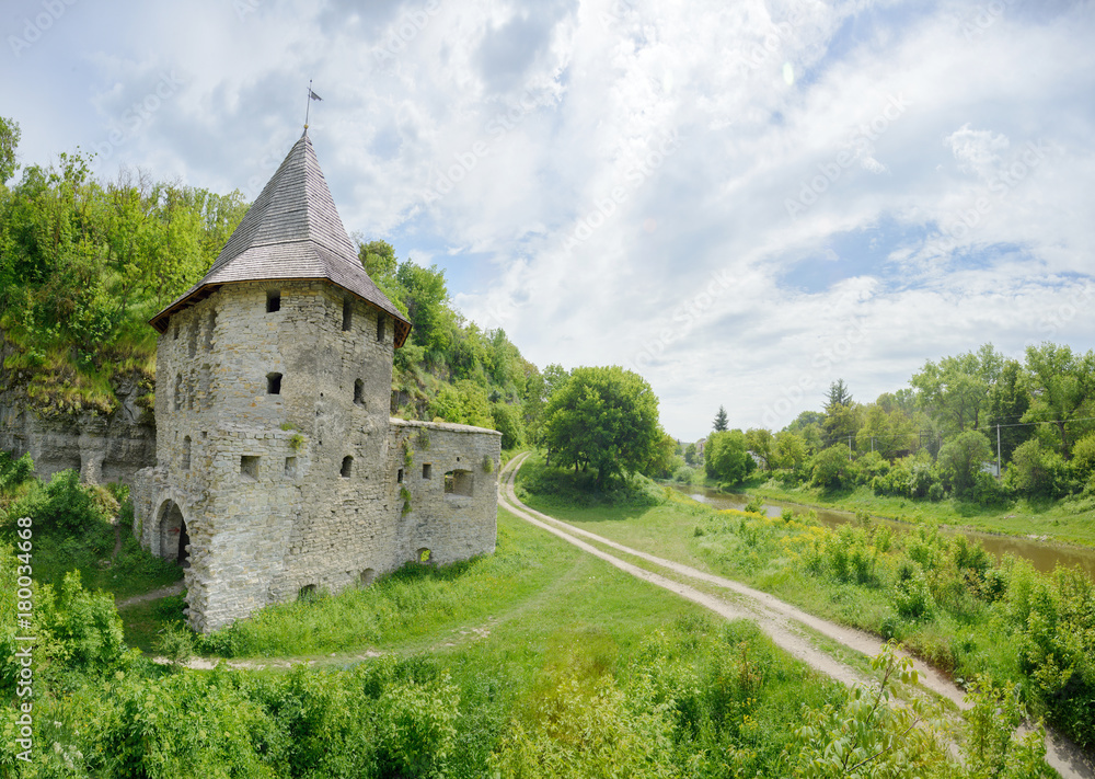 Old castle near river on cloudy sky background Old castle near river on cloudy sky background