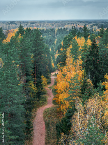 Picturesque view on valley of a national park. Trees changing colors in foothills.  Colorful Autumn day at Ogres Zilie kalni. photo