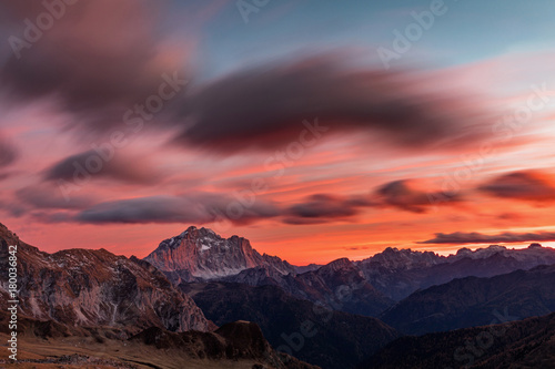 Colorful sunset in the background Dolomites and clouds in motion. Dolomites Alps, Italy,