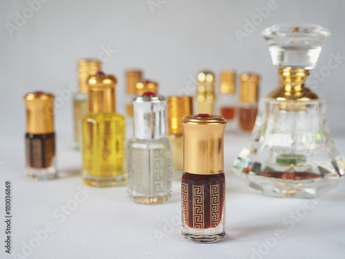 Close up shot of arabian oud oil made of agar wood in a beautiful glass jar. 
 photo