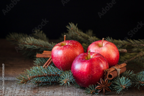 Christmas apples with cinnamon and badyan with branches of Christmas-tree