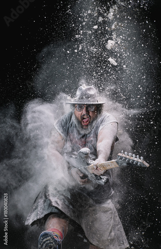 man with the guitar between chalk dust and smoke