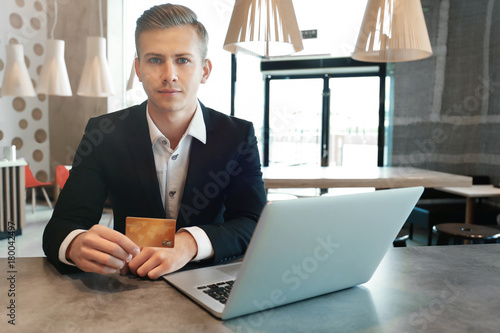 Young man using laptop and ...