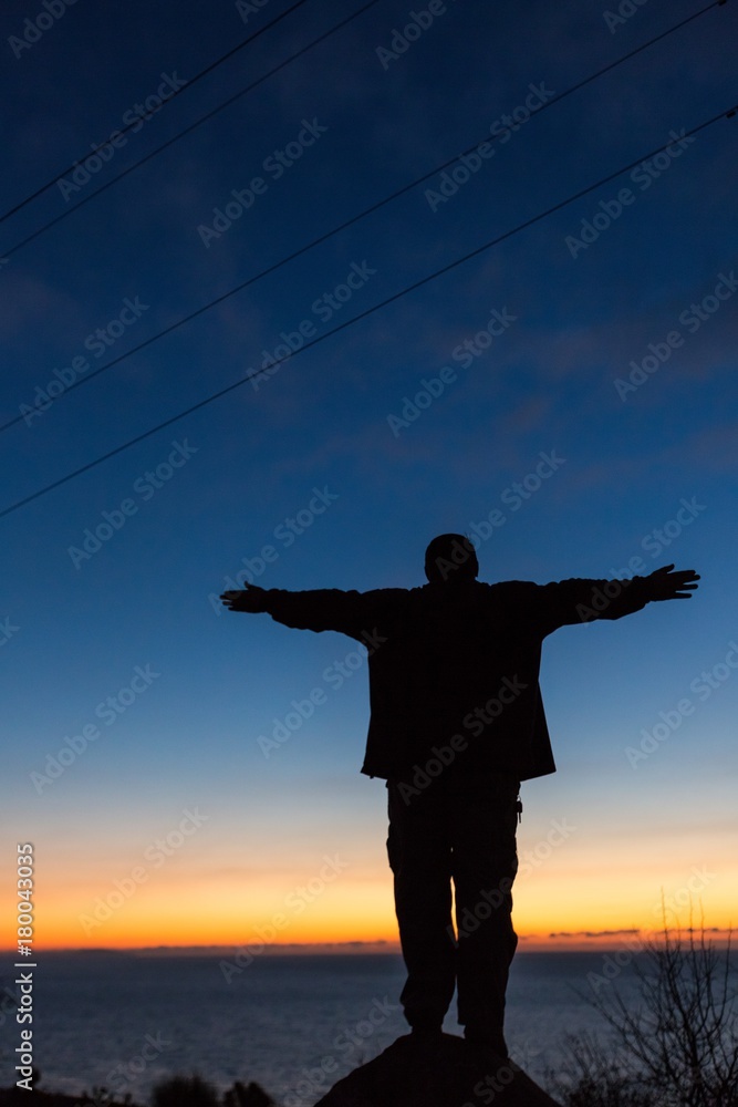 Fototapeta premium Man with Arms Open at Dawn / Sunset