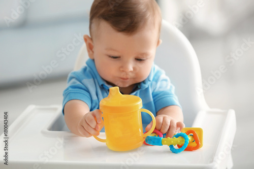 Cute baby with bottle of wa...