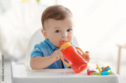 Cute baby drinking water in...