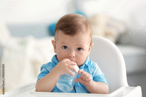 Cute baby drinking water in...