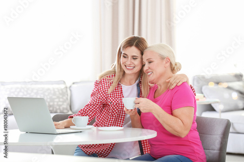 Young woman using laptop wh...