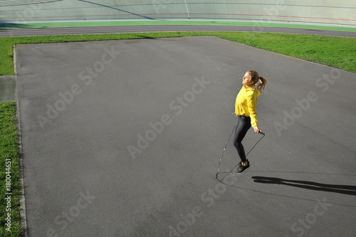 Sporty young woman jumping ...