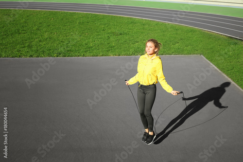 Sporty young woman jumping ...
