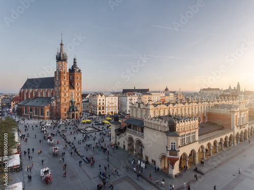 Old city center view in Krakow, aerial drone photography at sunset time, famous cathedral in evening light, the Cloth Hall in Poland photo