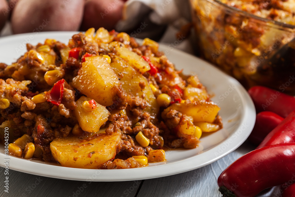 Portion of mexican potato casserole with minced meat Portion of mexican potato casserole with minced meat