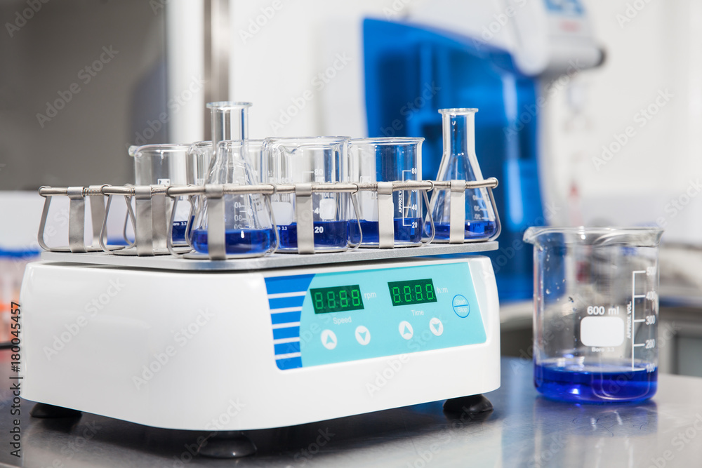 Laboratory shaker loaded with erlenmeyers and beakers Laboratory shaker loaded with erlenmeyers and beakers