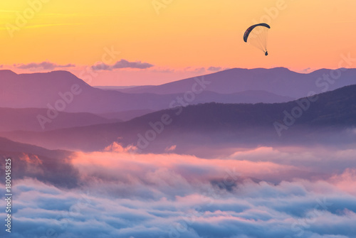 Paraglider over the sunset in a Crimea mountains