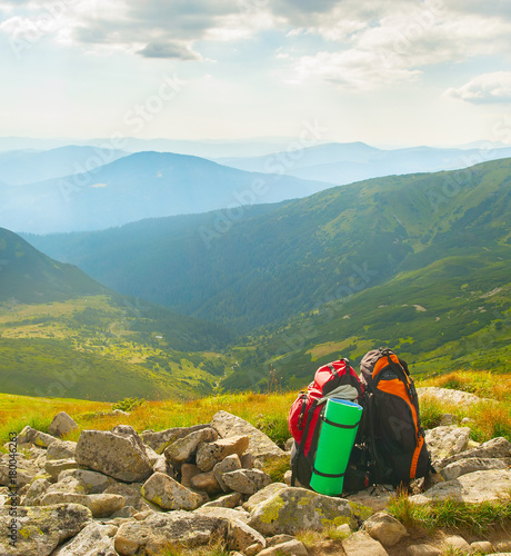 Two backpacks in mountains ...