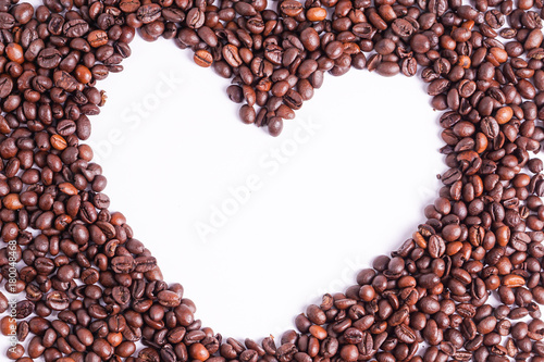 Heart made of coffee beans on with background