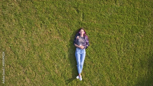 Overhead Aerial Drone Footage Of Woman Enjoying Music On Grass