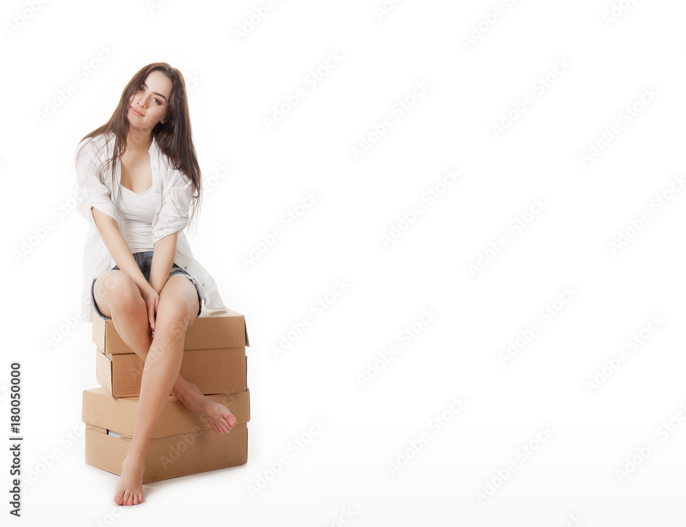 Sign people. Woman sitting on blank cardboard boxes. Casual young beautiful blonde model isolated on white background. Sign people. Woman sitting on blank cardboard boxes. Casual young beautiful blonde model isolated on white background.