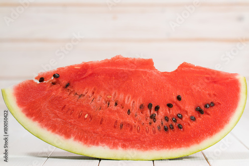 bitten slice of watermelon on a white background