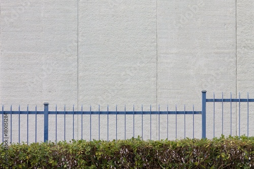 White wall behind blue grating (Pesaro, Italy)