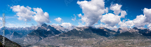Alpine mountains with shadows of clouds, large panorama photo