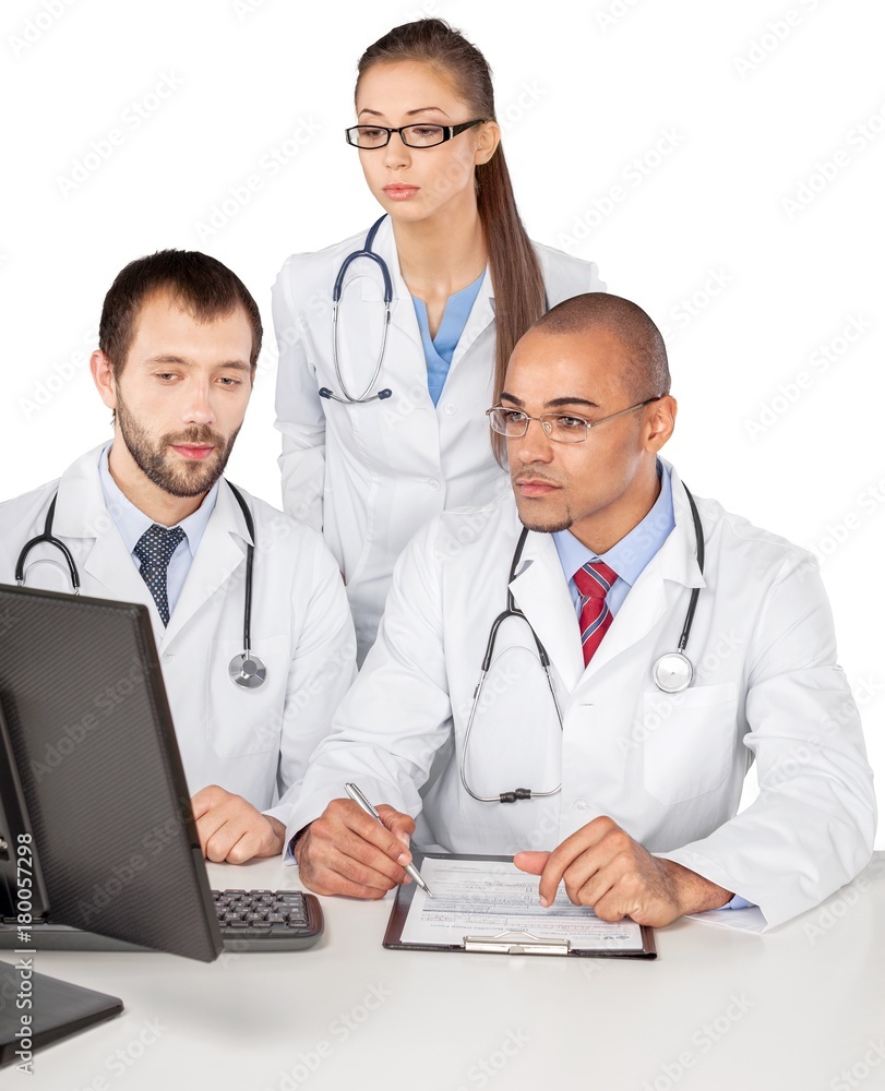 Portrait of Doctors Looking at Computer Monitor and Writing on Portrait of Doctors Looking at Computer Monitor and Writing on