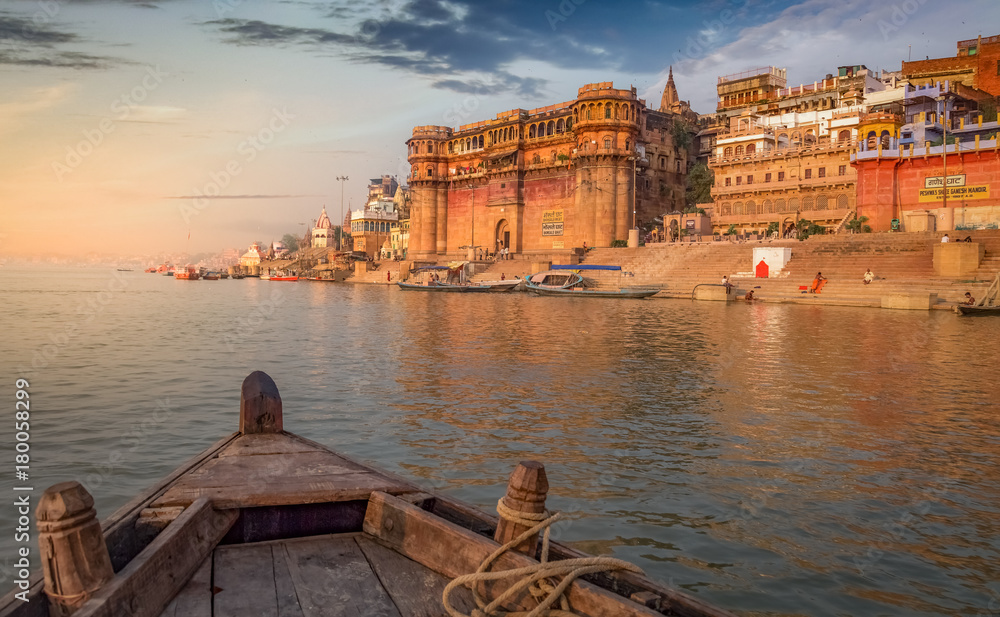 Ganges river boat ride at sunset overlooking the ancient Varanasi city, India.