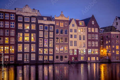 Night shot ofCanal houses on Damrak in Amsterdam