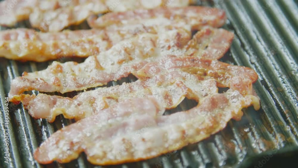 Steam Blowing Through Fresh Bacon On Grill Pan Steam Blowing Through Fresh Bacon On Grill Pan