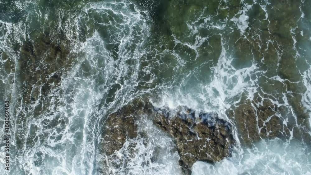 Aerial Zoom Out Shot Of Waves Washing Up On Rock Aerial Zoom Out Shot Of Waves Washing Up On Rock