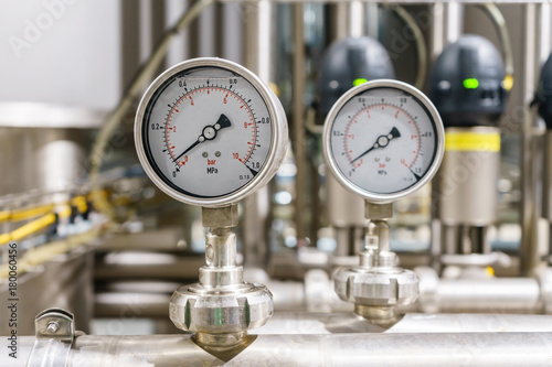 Pressure gauge, measuring instrument close up on pneumatic control system. photo