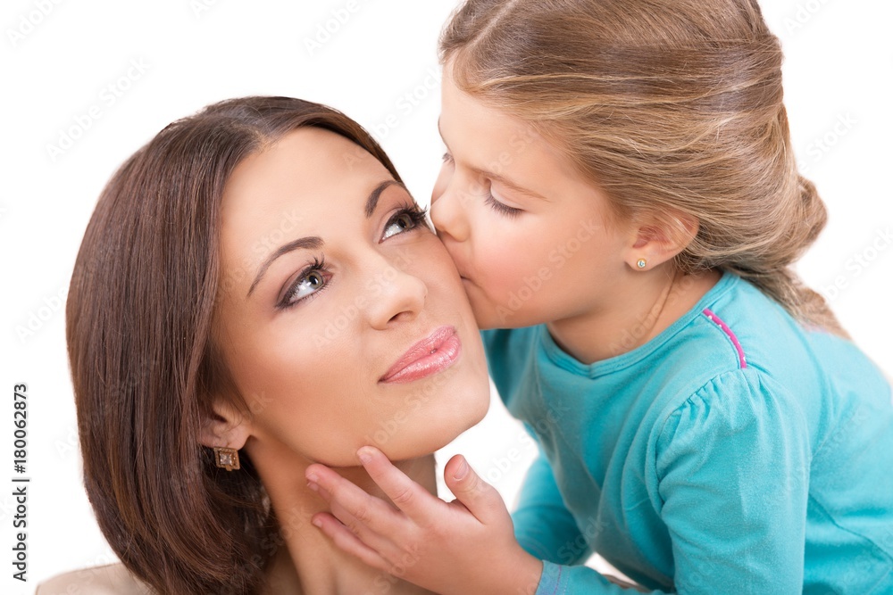 Closeup of a Young Daughter Kissing Her Mother Closeup of a Young Daughter Kissing Her Mother