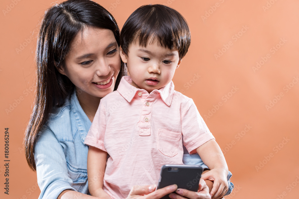 Mother and son looking at cellphone together Mother and son looking at cellphone together