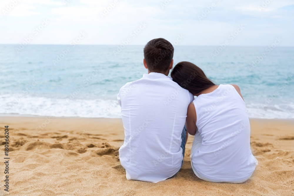 Couple on the Beach Looking at the Sea