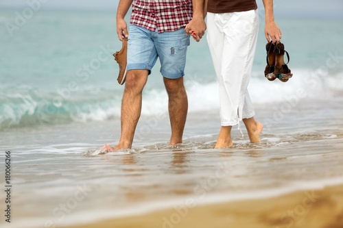 Closeup of a Couple Walking on the Beach