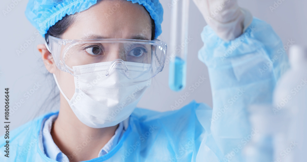 Female researcher with test tubes in laboratory Female researcher with test tubes in laboratory