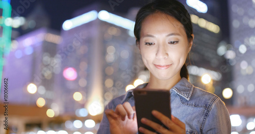 Canvas Print Asian woman using mobile phone in Hong Kong city