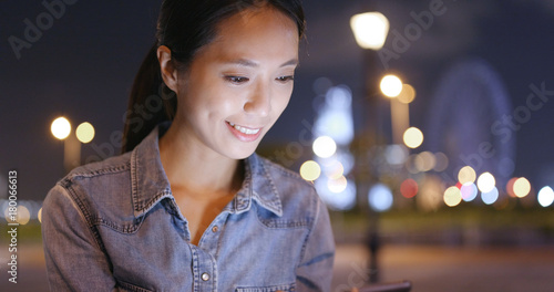Photography Woman working on cellphone in the city at night