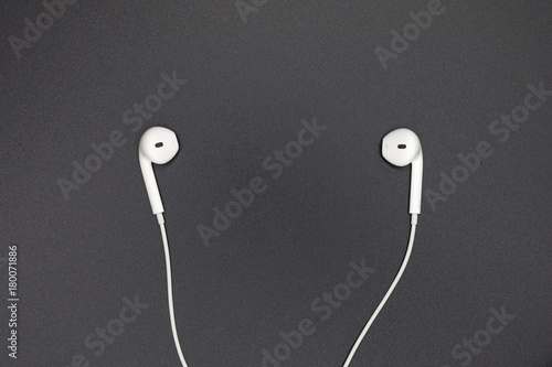 Top view of White Earphones on Black background. Copy space. Music is my life concept