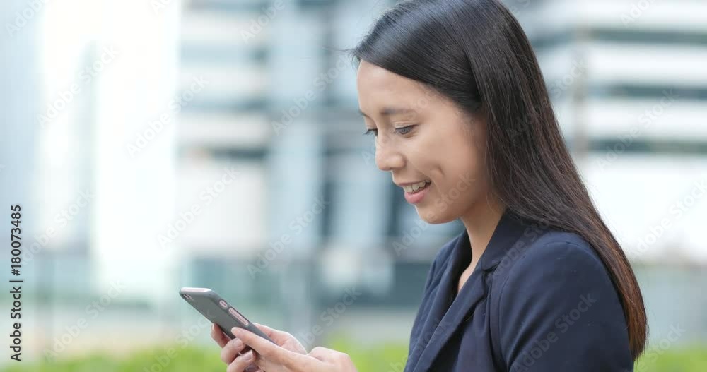 Businesswoman looking at mobile phone Businesswoman looking at mobile phone