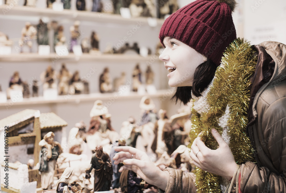 Beautiful teen girl  with miniature Christmas figures