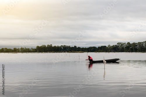 Rural fisherman sitting on a fishing boat.