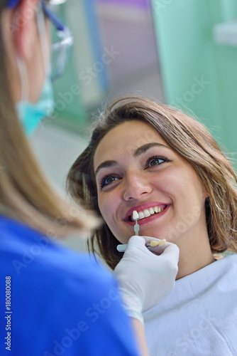 people  medicine  stomatology and health care concept - happy female dentist checking patient girl teeth