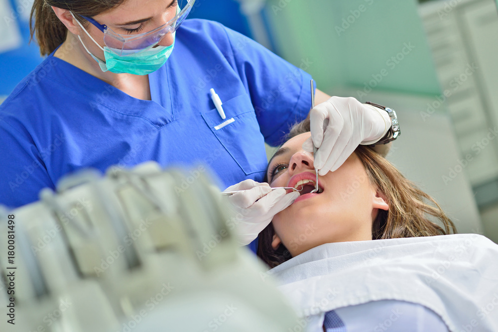 people, medicine, stomatology and health care concept - happy female dentist checking patient girl teeth people, medicine, stomatology and health care concept - happy female dentist checking patient girl teeth