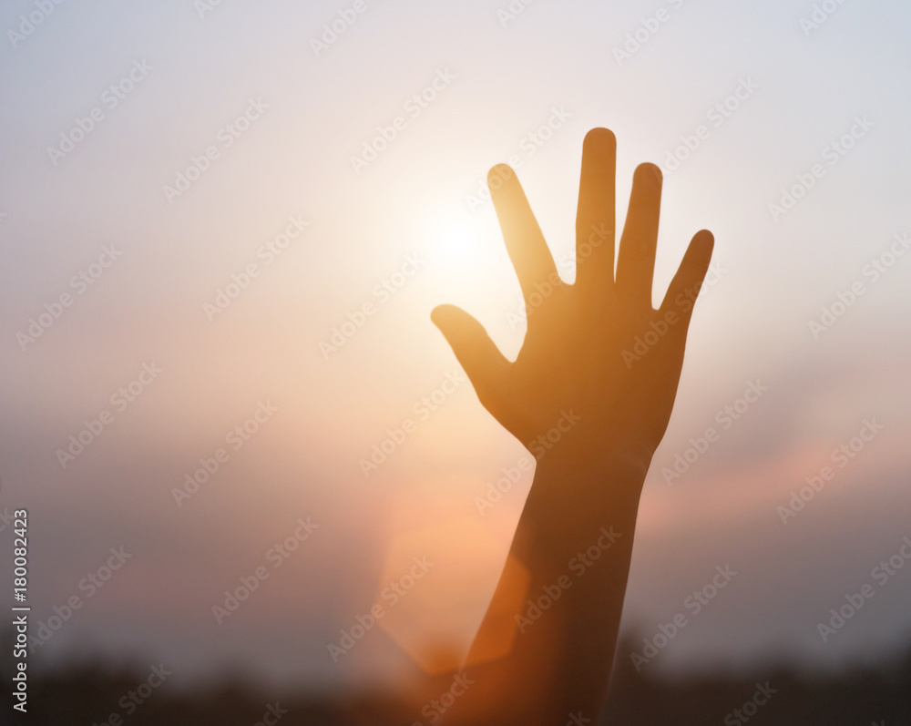 hands forming a shape with sunset silhouette