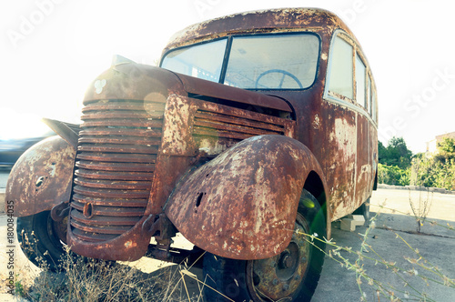 Old rusty bus abandoned at the edge of the road. © konik60