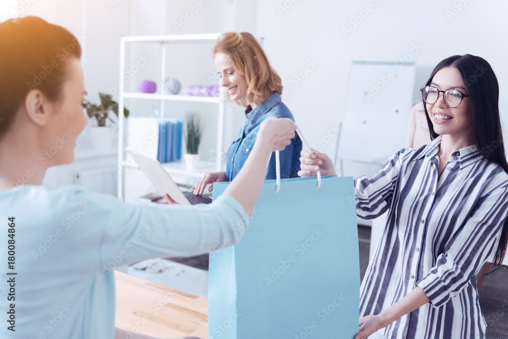 Regular client. Happy satisfied regular client getting her order in a fashionable expensive atelier Regular client. Happy satisfied regular client getting her order in a fashionable expensive atelier
